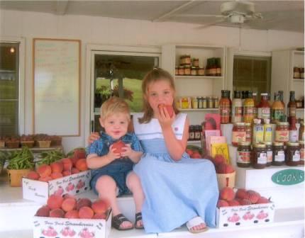 Kids eating peaches at Cooks roadside stand in Edgefield, SC